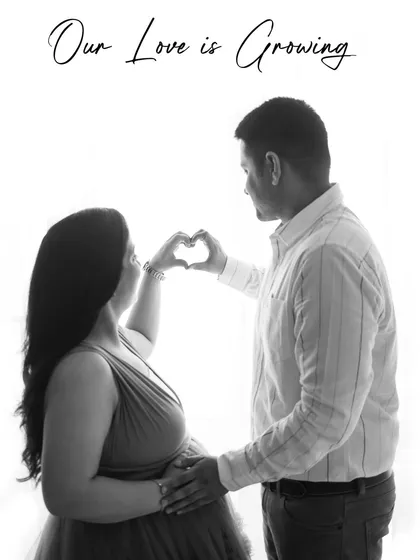A beautiful black and white silhouette of a couple forming a heart with their hands. The text overlay "Our Love is Growing" adds a sweet touch.