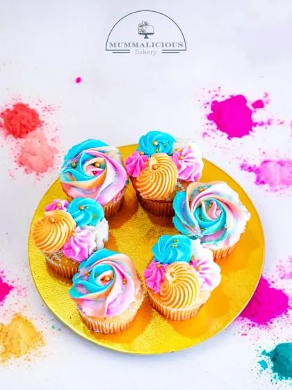 A beautiful platter of Holi-themed cupcakes. The multi-coloured frosting swirls are as vibrant and joyful as the festival itself.