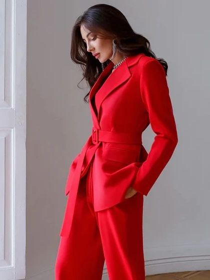 Command attention in this stunning red power suit. The belted blazer cinches at the waist to create a flattering silhouette, paired with matching wide-leg trousers.
