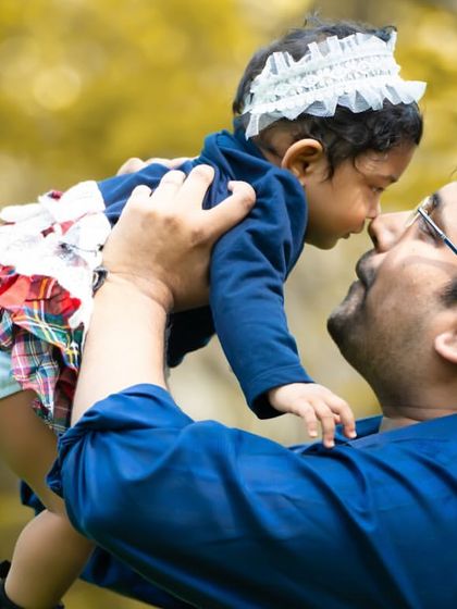 A father lifting his daughter up in the air. These playful, interactive shots are full of love and happiness.