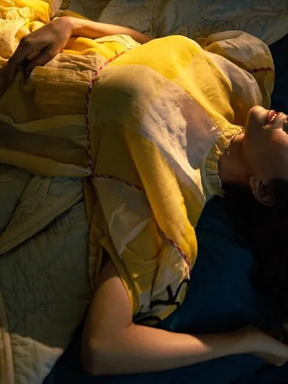 Using dramatic lighting from above, this shot captures Dipannita Sharma in a moment of serene repose, creating a cinematic and artistic fashion portrait.