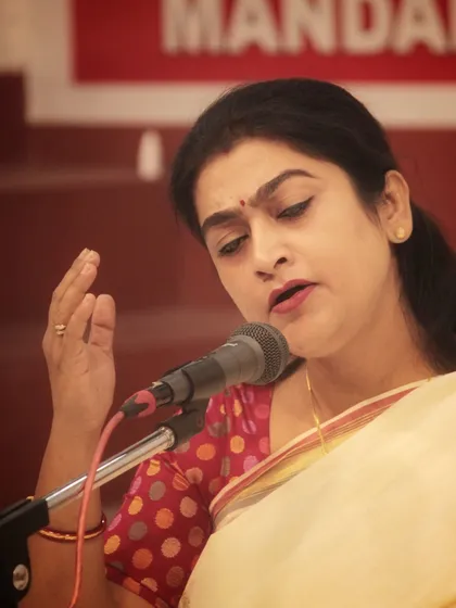 A student's performance, marked by graceful hand gestures that complement her vocal expressions. Singing is an art that involves the entire being.
