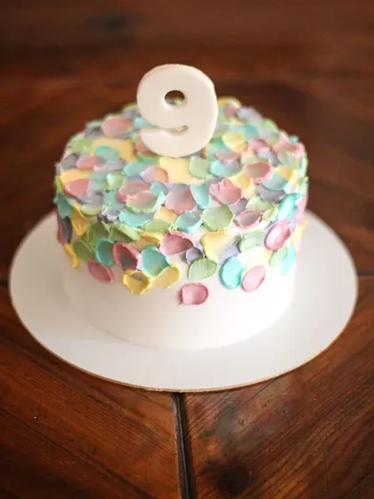 This design reminds me of a shower of confetti and pure joy! It's one of my most requested styles for birthdays because it's so simple, fun, and colorful. I use a palette knife to create these little dabs of pastel-colored frosting, making every cake unique.