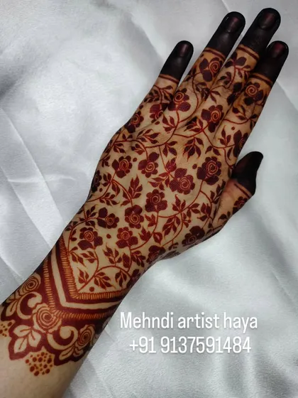 This angle shows how the dark stain provides a beautiful contrast against the skin, making the intricate design truly stand out.