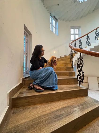 Sitting on the beautiful wooden staircase of our pet-friendly stay near Nandi Hills.