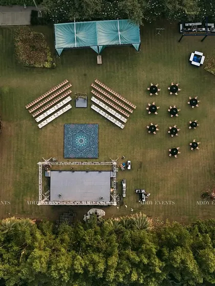 Our meticulous planning is visible from every angle. This aerial view reveals the precision of our event architecture, showcasing a symmetrical layout with designated zones for seating, performance, and guest interaction, ensuring optimal flow for a large-scale outdoor corporate event.