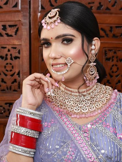 A lovely bride in a lavender lehenga. I used pink and purple tones in her makeup to match the outfit, creating a harmonious and pretty look.