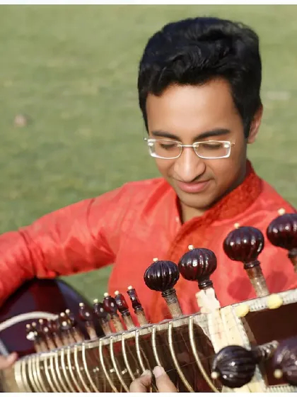 A close-up on my hands and the sitar's bridge during the outdoor shoot.