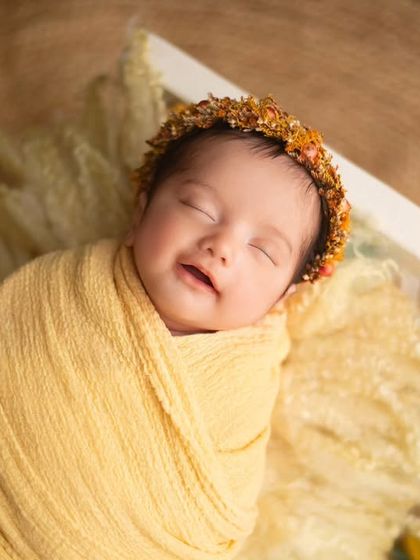 A soft, gentle smile from this little bundle of sunshine. The warm yellow tones of the setup perfectly match her happy mood.