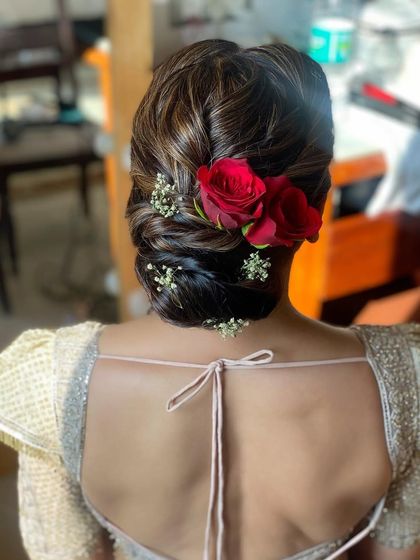Another view of the soft textured bun with red roses, created for the mother of the bride. It’s a classic and elegant choice that never goes out of style.