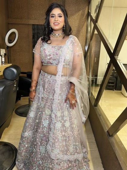 A full-length shot of this happy client. She is ready for the party in her beautiful pastel lehenga and my signature glam.