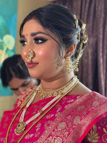 My bride Tejaswini, looking stunning for her traditional Marathi wedding. She wore a beautiful pink saree, and we created a classic look with a sharp winged liner and a traditional crescent bindi.