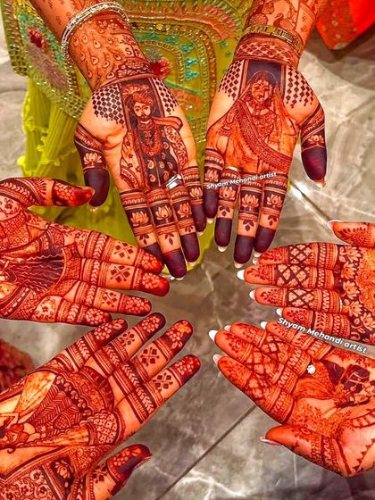 A group shot showing the bride's portrait mehandi alongside the simpler designs of her bridesmaids.