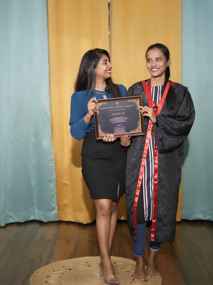 This graduate is all smiles as she receives her certificate of completion.