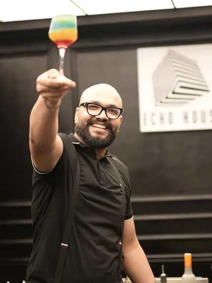 Cheers from one of our expert mixologists. We call this colorful creation the 'Rollercoaster' because it's a journey of sweet and sour flavors, just like life. We love interacting with guests and making sure everyone has a great time.