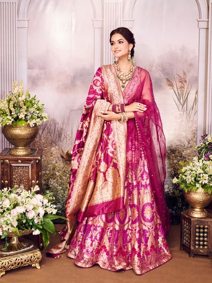 The full view of the magenta Banarasi outfit, showcasing its royal color and intricate gold weaving. A timeless piece for any bride's trousseau.