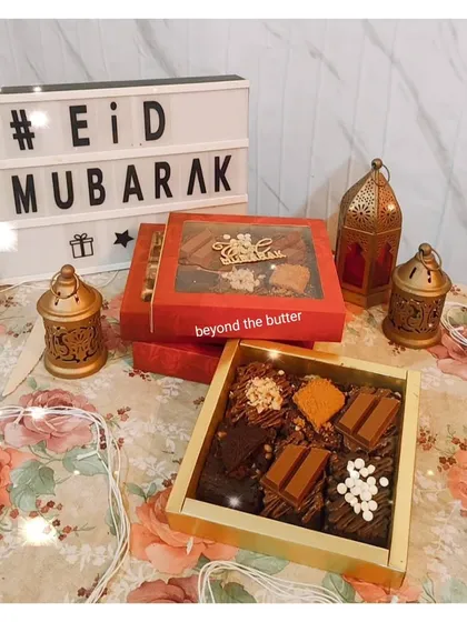 An assortment of my fudgy brownies ready for an Eid celebration. This box includes different toppings like KitKat, Biscoff, and white chocolate chips, offering a little something for everyone.