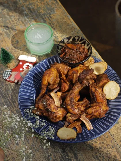 A plate of our festive Kuttanad Duck Olarthu. The rich, dark meat is beautifully complemented by fried coconut slices and potatoes, making it an unforgettable part of your Christmas feast.