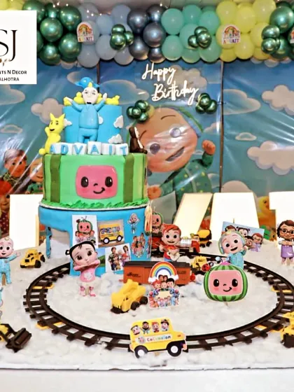 Another view of the detailed Cocomelon cake and marquee letters spelling out the birthday boy's name, Advait.