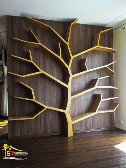 This tree-shaped bookshelf is a perfect example of how we turn a client's unique vision into functional art. Custom-built from plywood with a light wood finish against a dark veneer backdrop, it serves as a stunning focal point and a practical display unit in this room.