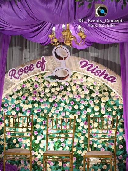 A detailed shot of the Roce ceremony backdrop, featuring a flower wall and a custom sign with coconut motifs, which are significant in this traditional ceremony.