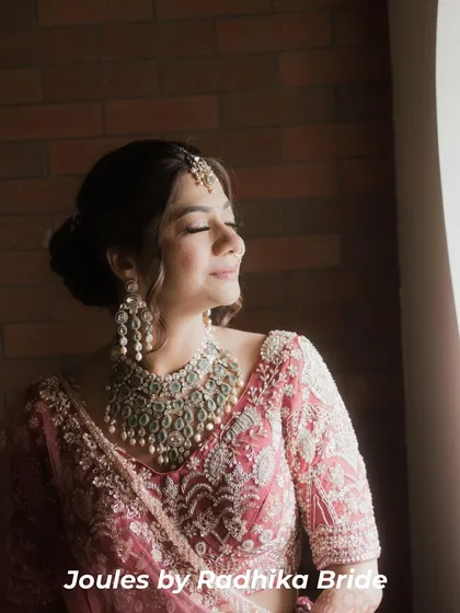 Serenity and sparkle. Our bride looks ethereal in a statement silver-toned polki necklace with pearl accents, perfectly matching the intricate embroidery of her rose-pink bridal lehenga.