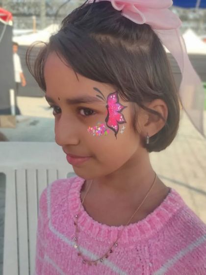 A simple and sweet pink butterfly with a sprinkle of glitter, a quick and popular choice for younger children.