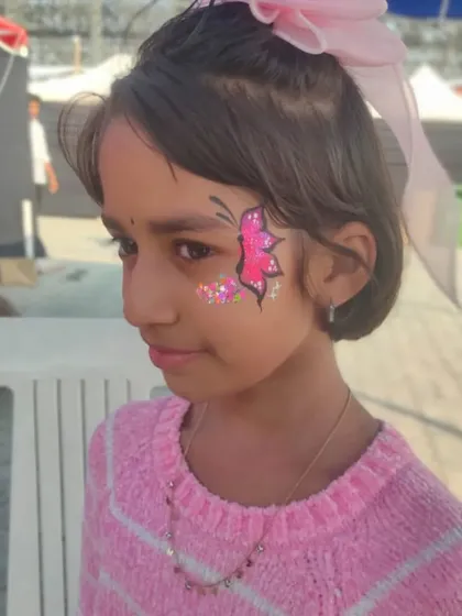 A simple and sweet pink butterfly with a sprinkle of glitter, a quick and popular choice for younger children.