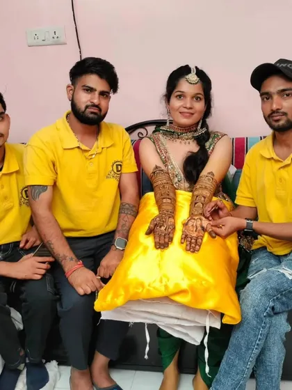 A photo with a client showing her completed bridal mehndi. My team is trained to be professional and friendly, making the experience enjoyable for everyone.