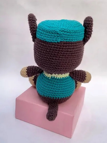The back view of the Chase amigurumi, showing his cap and the details of his uniform. Every part is crocheted and stitched securely.