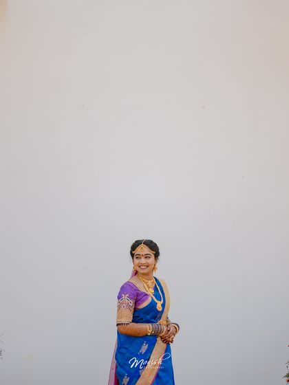 A minimalist portrait of the beautiful South Indian bride in her traditional blue and purple silk saree.