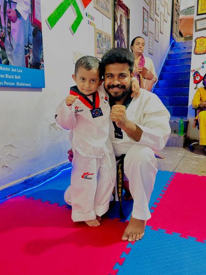 A coach and his student. I believe in building a strong, supportive bond with every child, helping them grow not just as fighters, but as individuals.