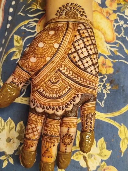 A beautiful Teej festival design. This style uses a mix of grids, dots, and leaf patterns to create a full but not overly heavy look.
