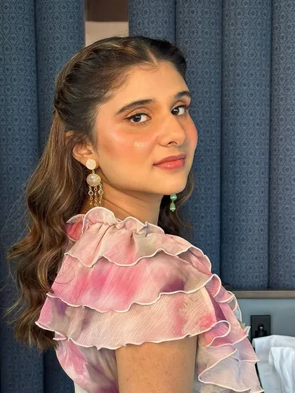 A beautiful floral glam look for a wedding guest. The makeup is kept minimal and fresh to complement the soft, romantic vibe of her ruffled dress.