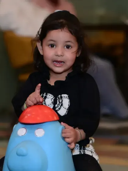 This little one is ready to ride! Our play area includes various ride-on toys that are perfect for toddlers to explore and move around.