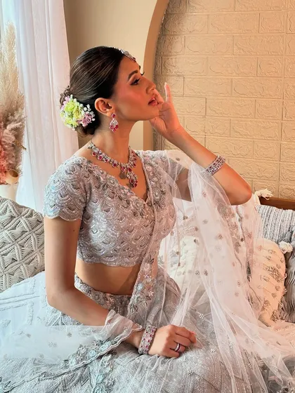 A serene side profile, highlighting the beautiful floral bun and the soft, glowing makeup. This look is perfect for a bride who wants to feel both modern and timeless.