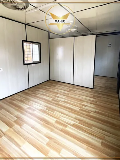 This unfurnished office container is ready for dispatch and customization. The image shows the clean interior finish, durable wood-laminate flooring, and partition walls that can be configured to create private offices, meeting rooms, or open-plan work areas.