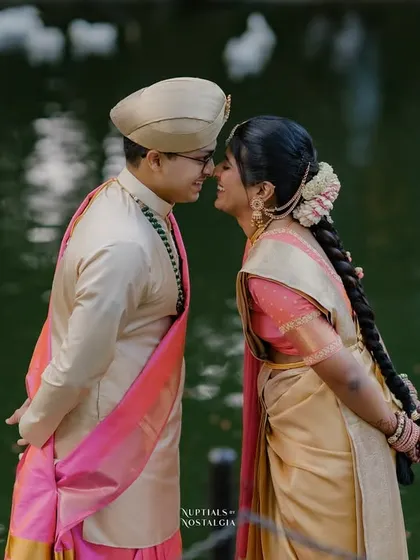 A playful, almost-kiss moment by the pond, with the ducks swimming in the background, adding a touch of life and spontaneity.