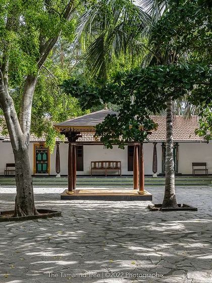 The Atithishala Mandap courtyard, a versatile open space surrounded by traditional architecture, perfect for daytime functions.