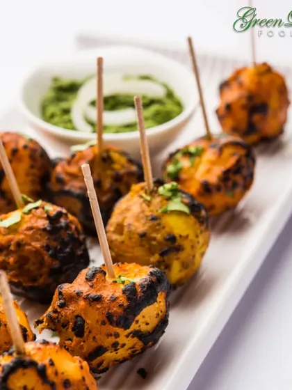 Our Tandoori Aloo Tikka is a must-try. Baby potatoes are marinated in a spicy yogurt mixture and roasted until tender and slightly charred, creating a smoky and flavorful Indian appetizer.