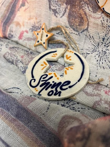 The 'Shine On' affirmation ornament, another piece designed to bring positivity to your home.