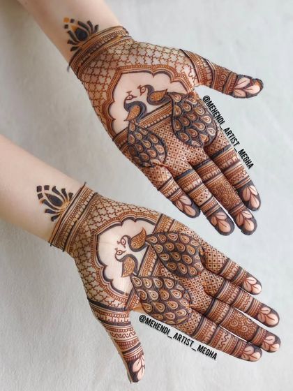 A clean and elegant design focusing on twin peacocks on the palms, framed by a simple net pattern and a lotus motif on the wrist.