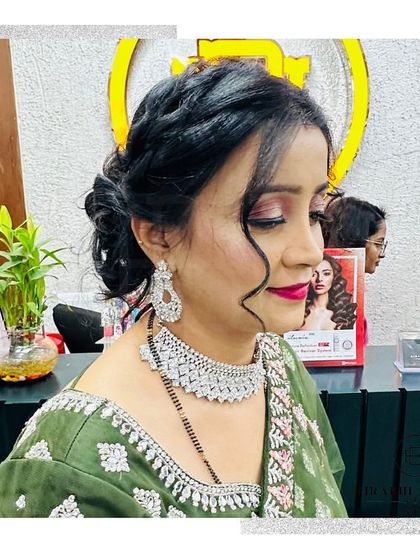 Another angle of this elegant party look. The soft, romantic updo and glowing makeup are perfect for any celebration.