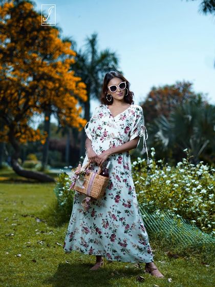 This pose with a wicker basket and sunglasses creates a complete, styled look perfect for a spring or summer fashion catalogue.