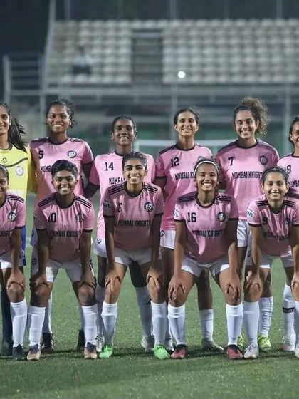 The team photo before a night game, looking sharp in our pink kits.