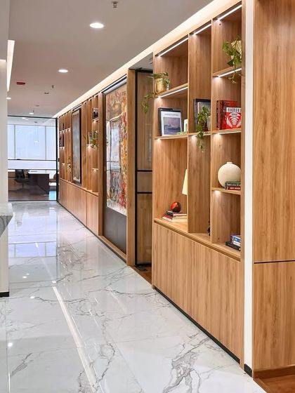 The modern and elegant corridor of our new Bengaluru office, designed with clean lines and warm wood finishes to create a welcoming atmosphere for clients and our team.