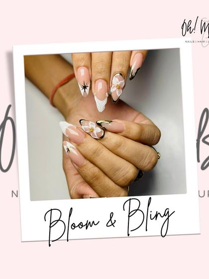 Bloom and bling come together in this elegant design. It features a modern French manicure with black and chrome tips, accented with delicate 3D flowers and sparkling details.