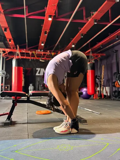 A forward fold is a great way to stretch the hamstrings and release tension in the lower back after a tough workout. Flexibility is a key component of a balanced fitness program.