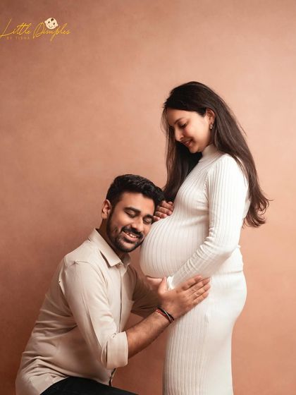 The father-to-be listening to the baby bump is a classic and heartwarming pose that I love to capture in my studio sessions.