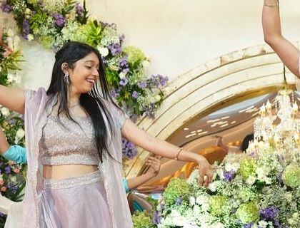 A candid moment of joy from an engagement ceremony performance. This photo captures the pure happiness and energy of the dancers.